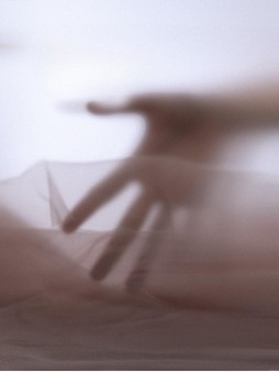 Hand silhouette underneath translucent gauze in the PinkMoire visual study